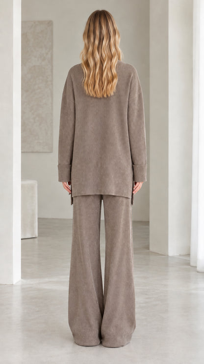 Back view of model wearing relaxed fit taupe ribbed knit two-piece set