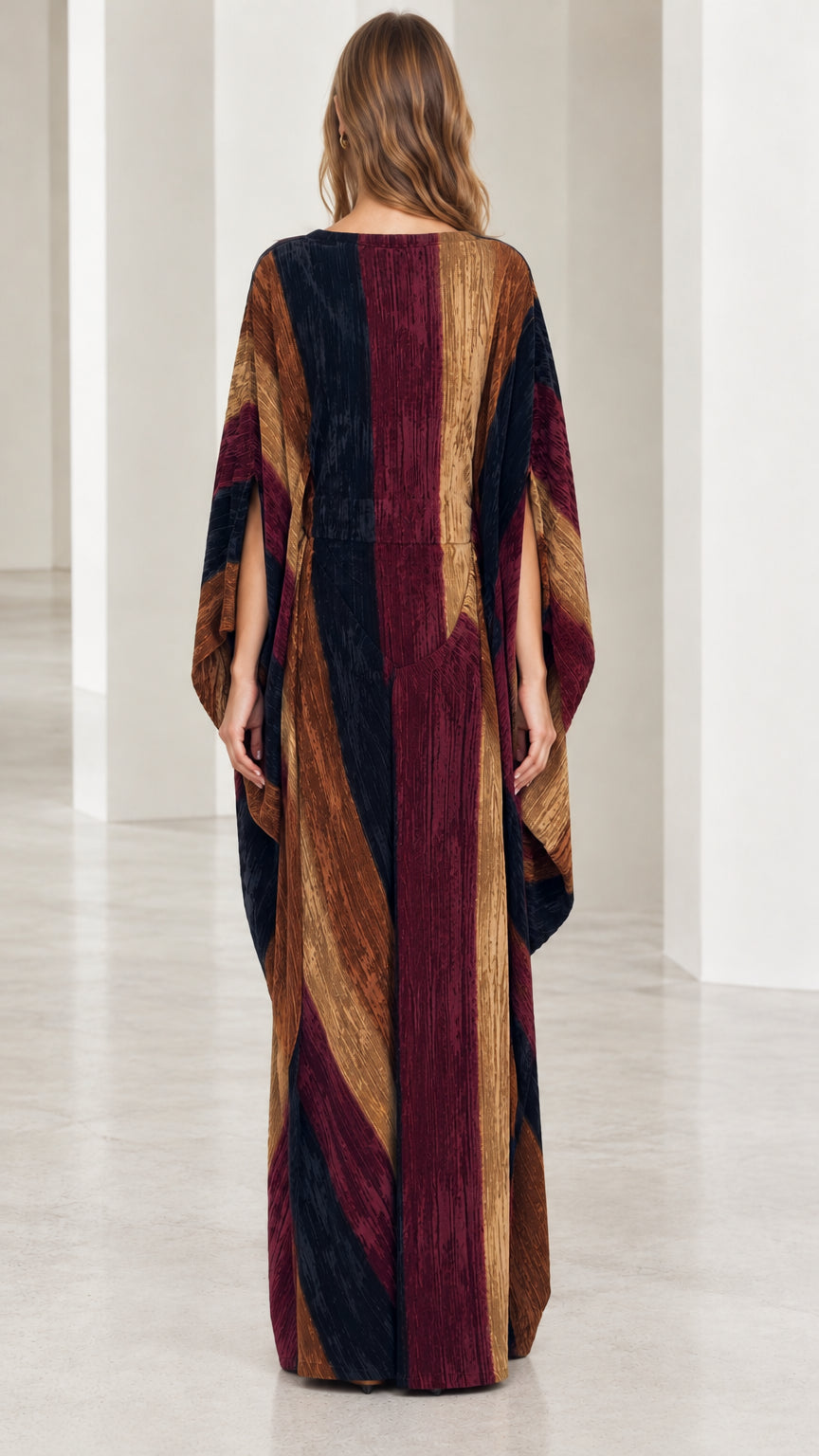 Back full-length view of model in striped burgundy multi kaftan dress