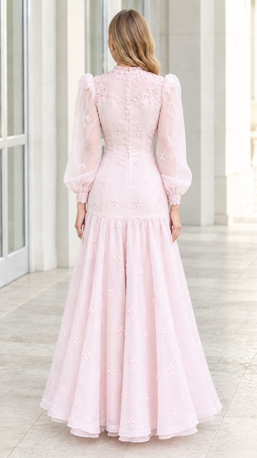 Back view of model wearing blush pink long sleeve formal evening gown
