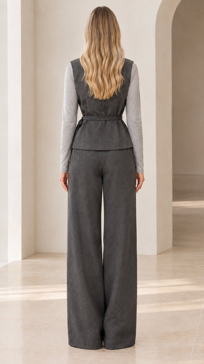 Back view of charcoal grey sleeveless vest and wide-leg suit trousers