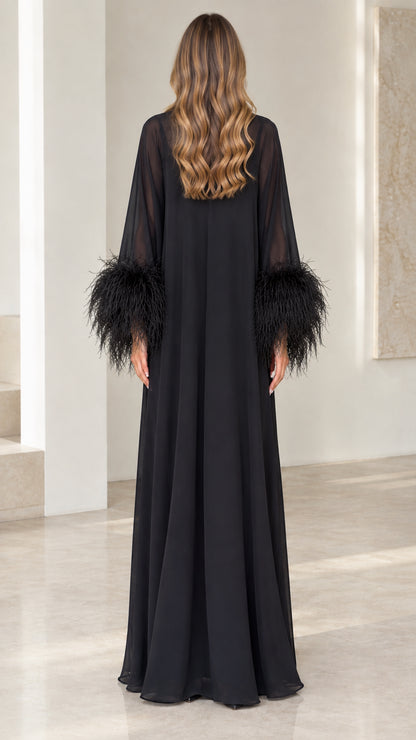 Back view of floor-length black sheer yoke evening gown