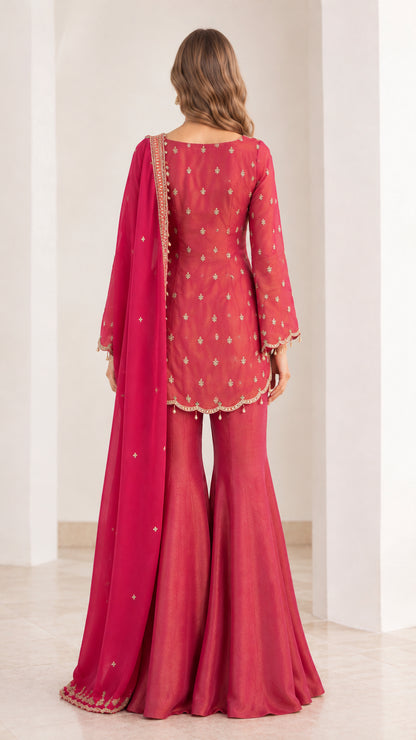 Back view of Berry Pink embroidered sharara suit set with flowing dupatta