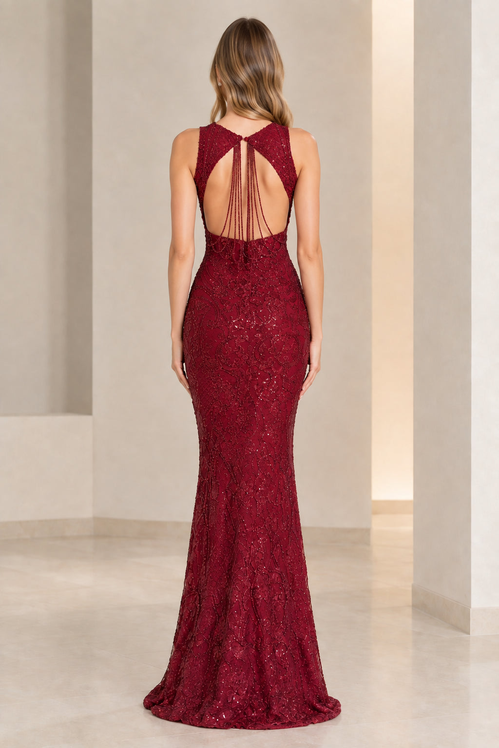 Back view of burgundy formal dress showing keyhole cutout with draped beaded string details