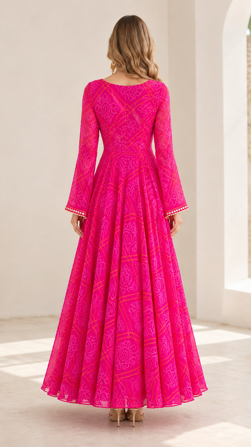 Back view of model in hot pink printed bell sleeve floor-length dress