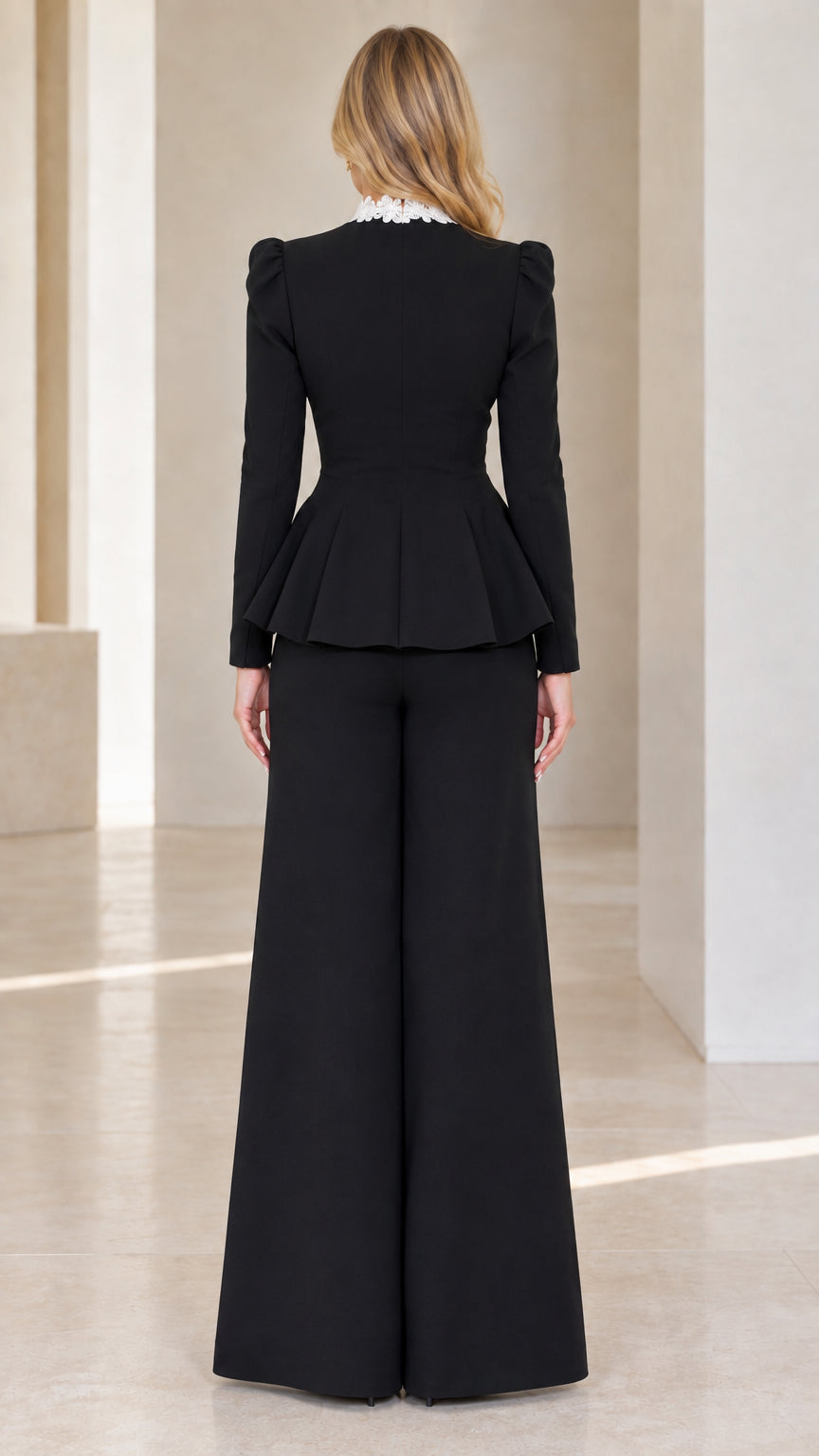 Back view of black peplum suit set with lace collar and flared wide-leg trousers