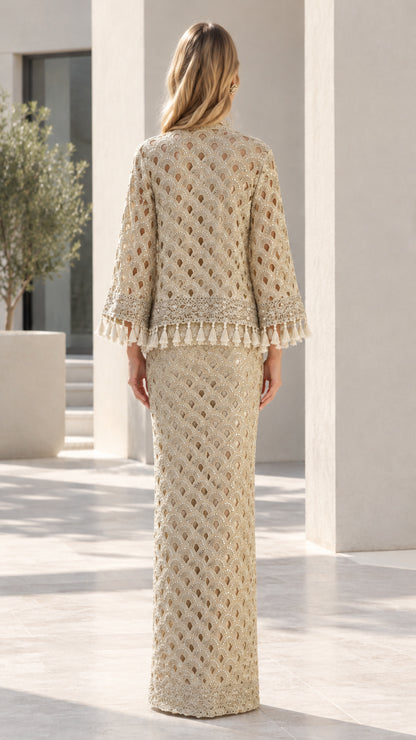 Back view of woman wearing Champagne embellished maxi skirt and tassel cardigan set
