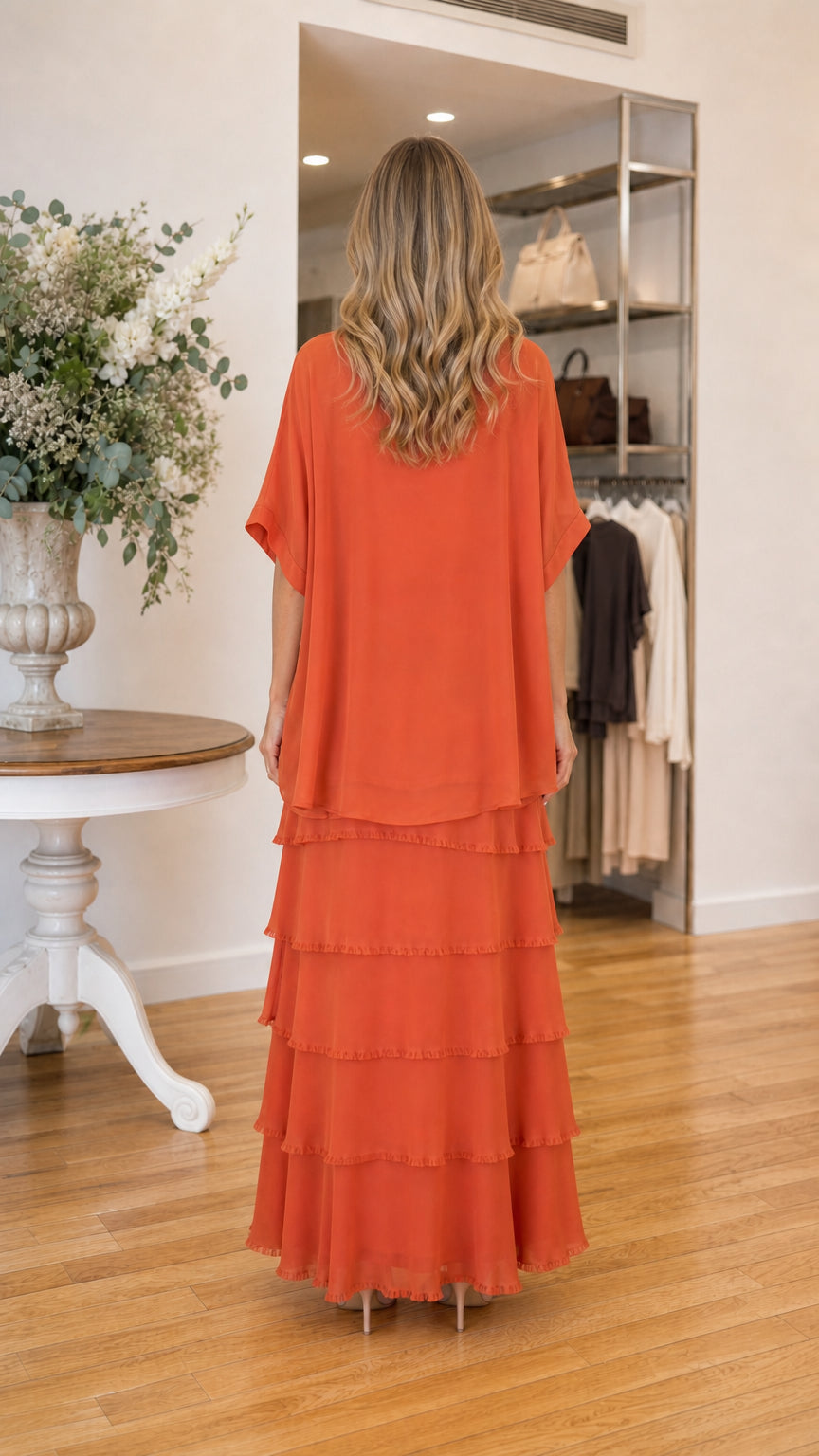 Back view of model in rust orange maxi dress