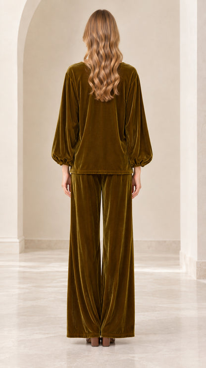 Back view of model wearing olive green velvet pant set