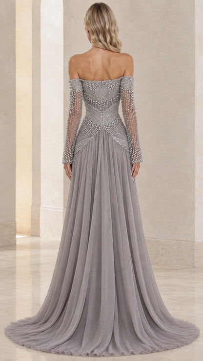 Back view of model showing off-the-shoulder back and flowing slate gray chiffon skirt