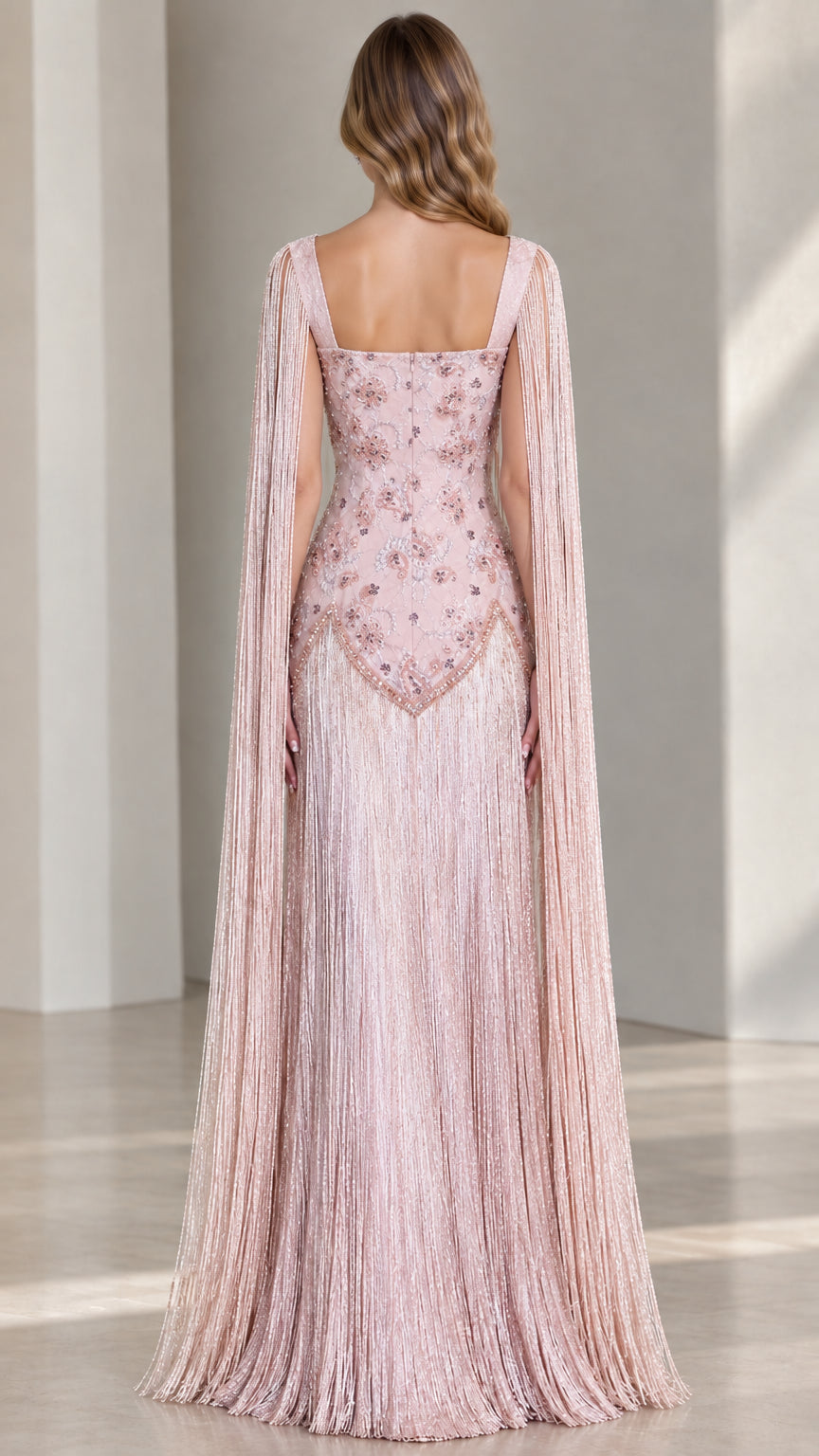 Back view of dusty pink fringe cape sleeve maxi evening gown