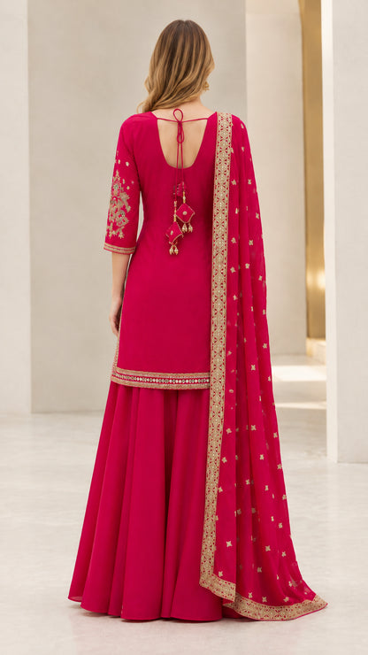 Back view of fuchsia sharara suit showing back neckline tie detail with tassels
