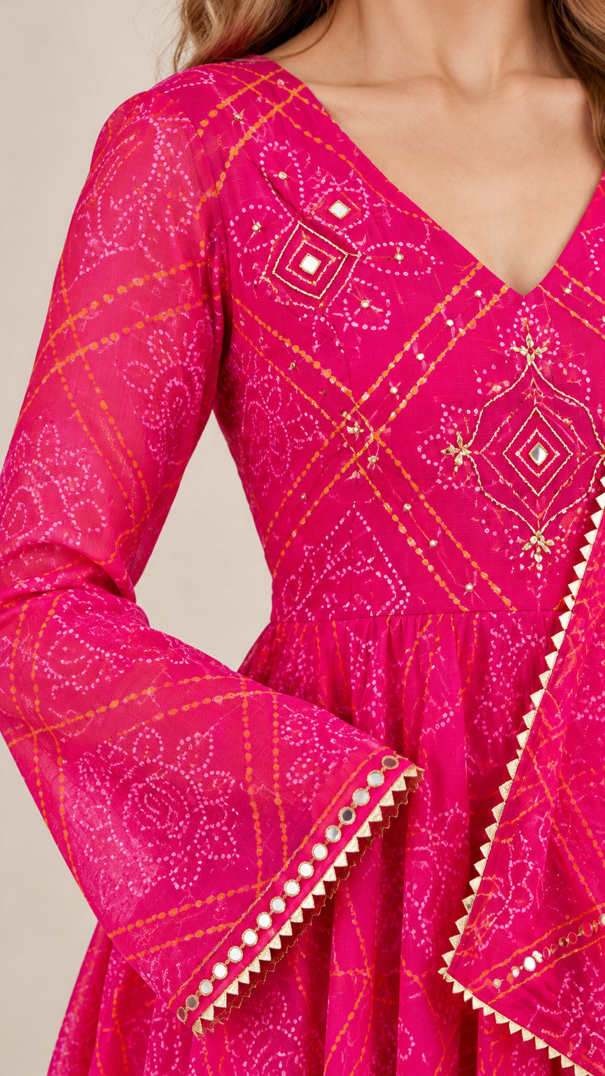 Close-up detail of V-neckline embroidery and flared sleeve cuff on hot pink gown