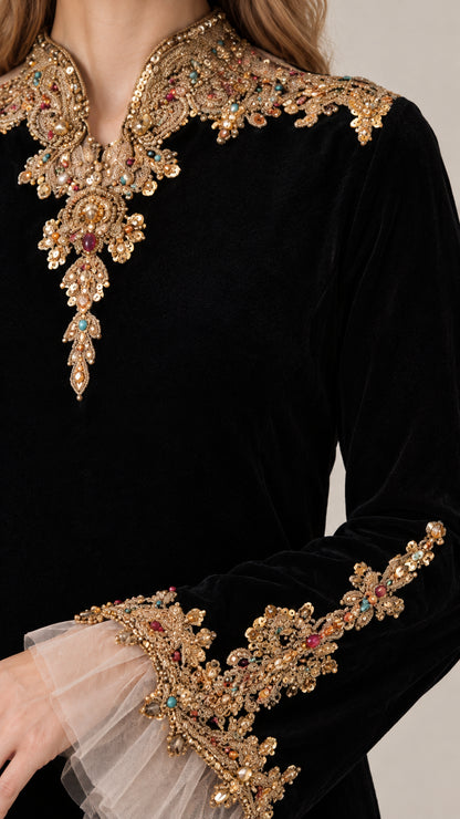 Close-up detail of ornate gold embroidery and beading with pleated sheer cuff trim