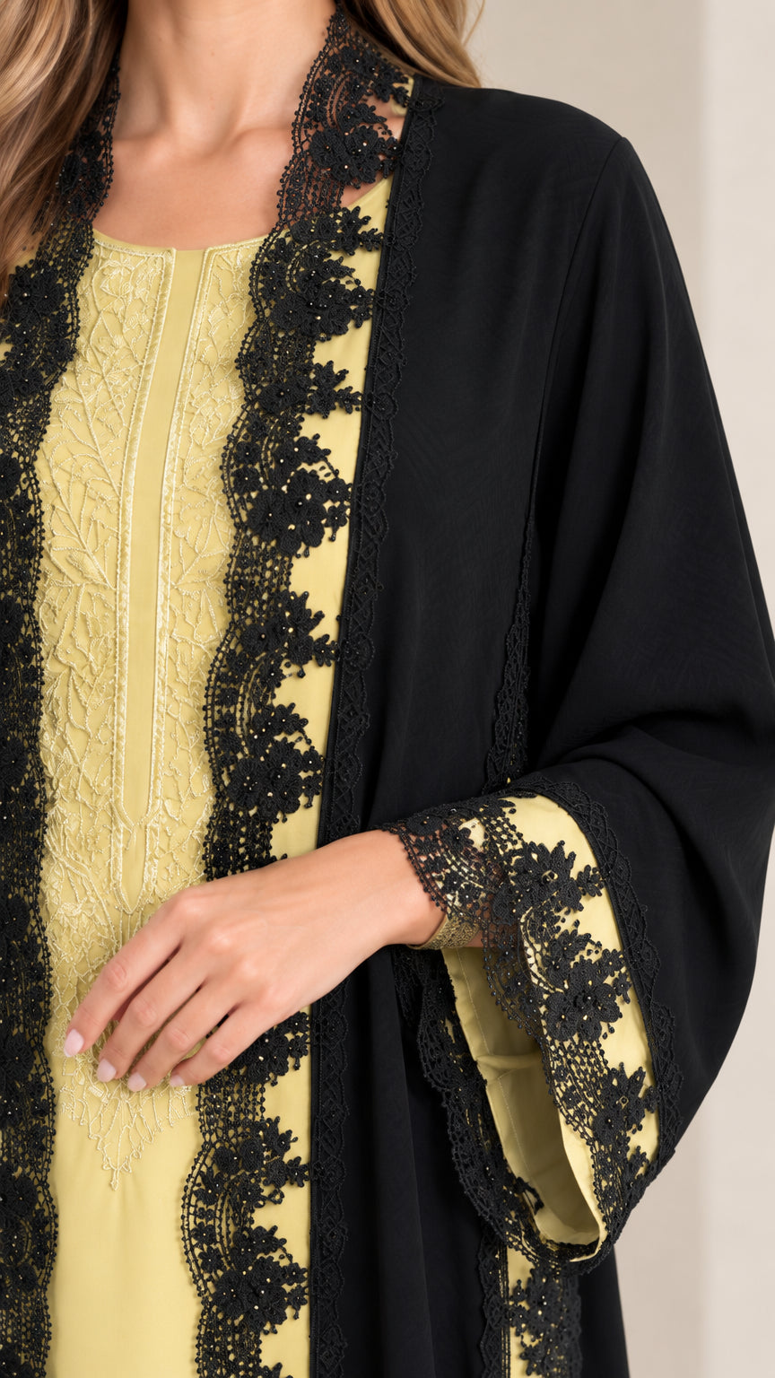 Close-up of black floral lace trim and embroidered bodice detail