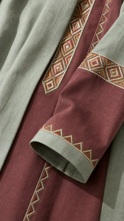 Close-up detail of geometric embroidery on sleeve and lapel