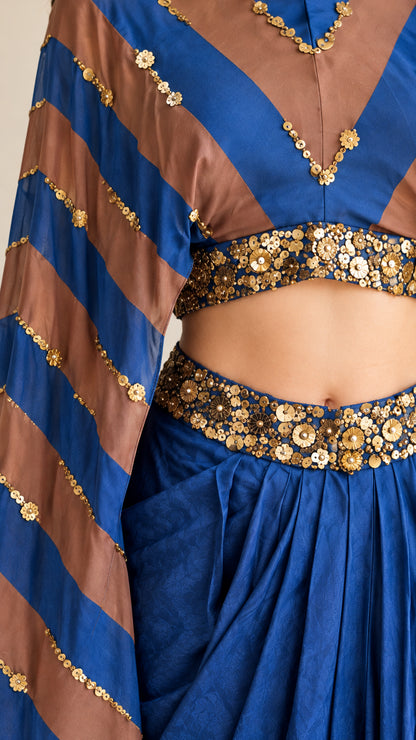 Close-up detail of sequin and bead embellishments on waist and striped sleeve fabric