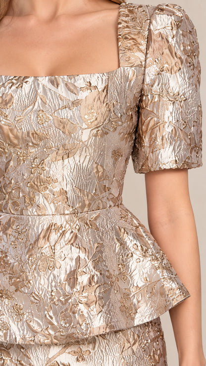 Close up texture detail of champagne metallic floral jacquard fabric and peplum waist