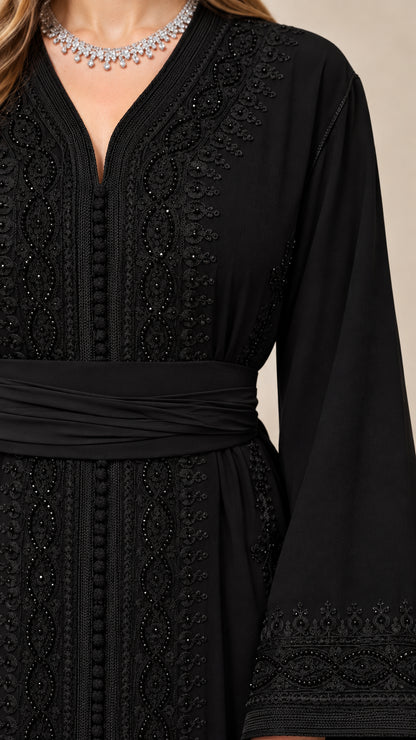 Close-up detail of intricate tonal embroidery on the V-neckline and waist sash