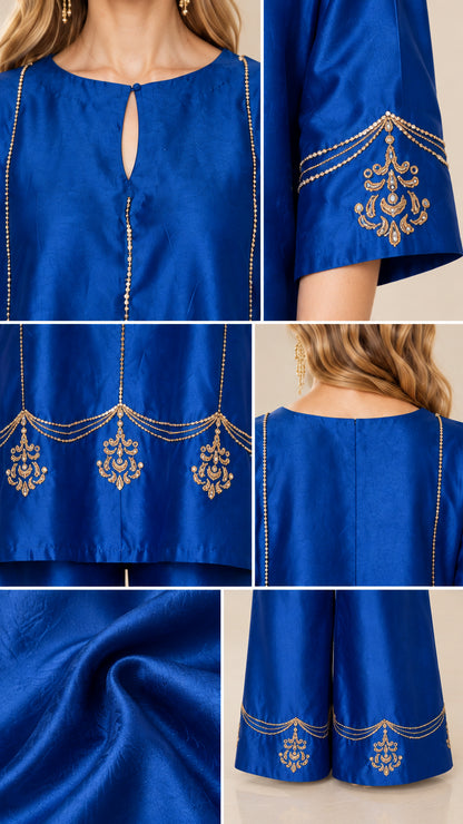 Close-up details of royal blue tunic neckline, cuff embroidery, hem border, and fabric texture