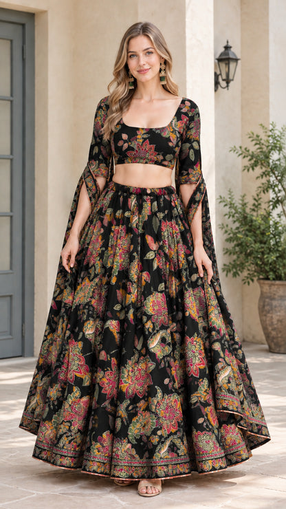 Front view of model wearing Black floral crop top and flared maxi skirt set with cape sleeves