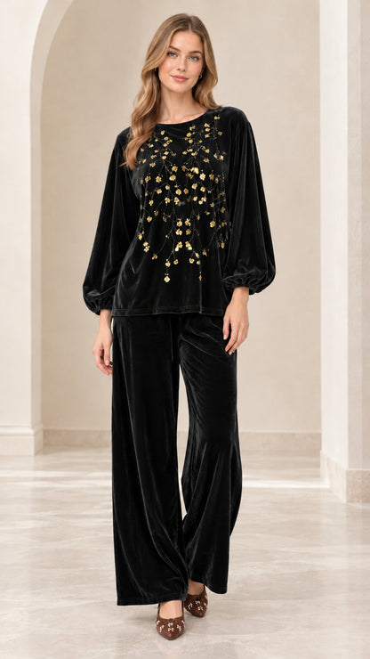 Front view of women's black velvet two-piece set with gold floral sequins