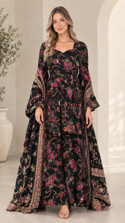 Model wearing black floral print tiered maxi dress with matching drape