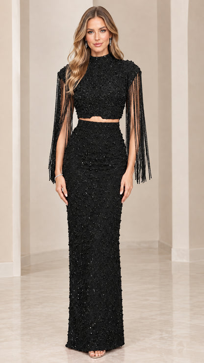 Front view of black beaded two-piece mock neck evening gown with fringe sleeves
