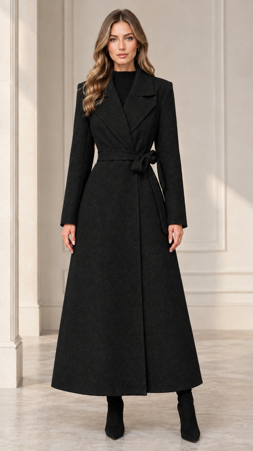 Front view of woman wearing the black belted maxi wrap coat
