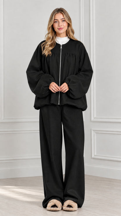 Full-body view of black two-piece zip jacket and wide-leg lounge set