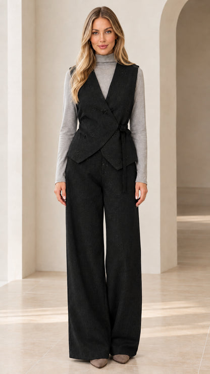 Woman wearing black wrap tie vest and matching wide-leg suit pants