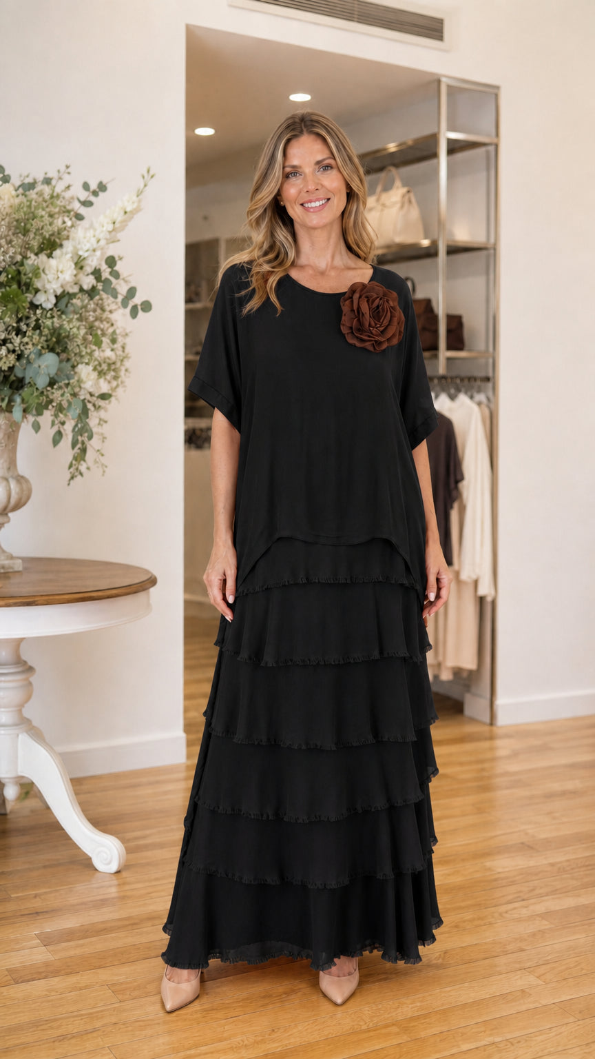 Model wearing black tiered ruffle maxi dress