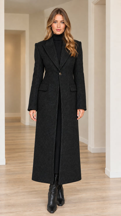 Model wearing black single-button tailored maxi overcoat with black boots