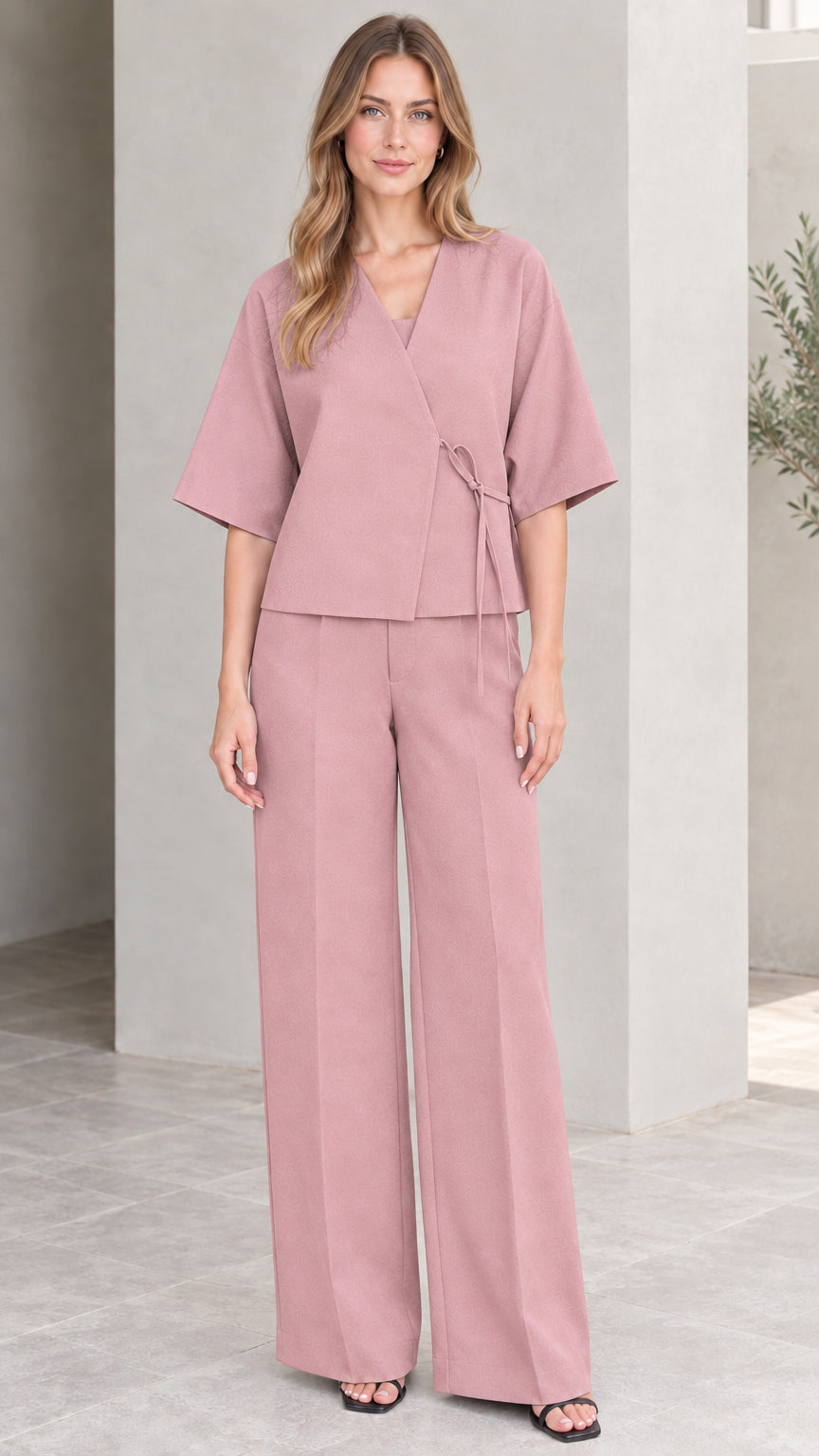 Full-length view of model wearing dusty pink wrap top and wide-leg pants set