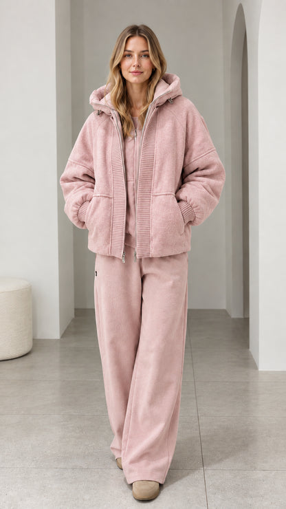 Front view of model wearing dusty pink textured fleece hooded zip-up jacket