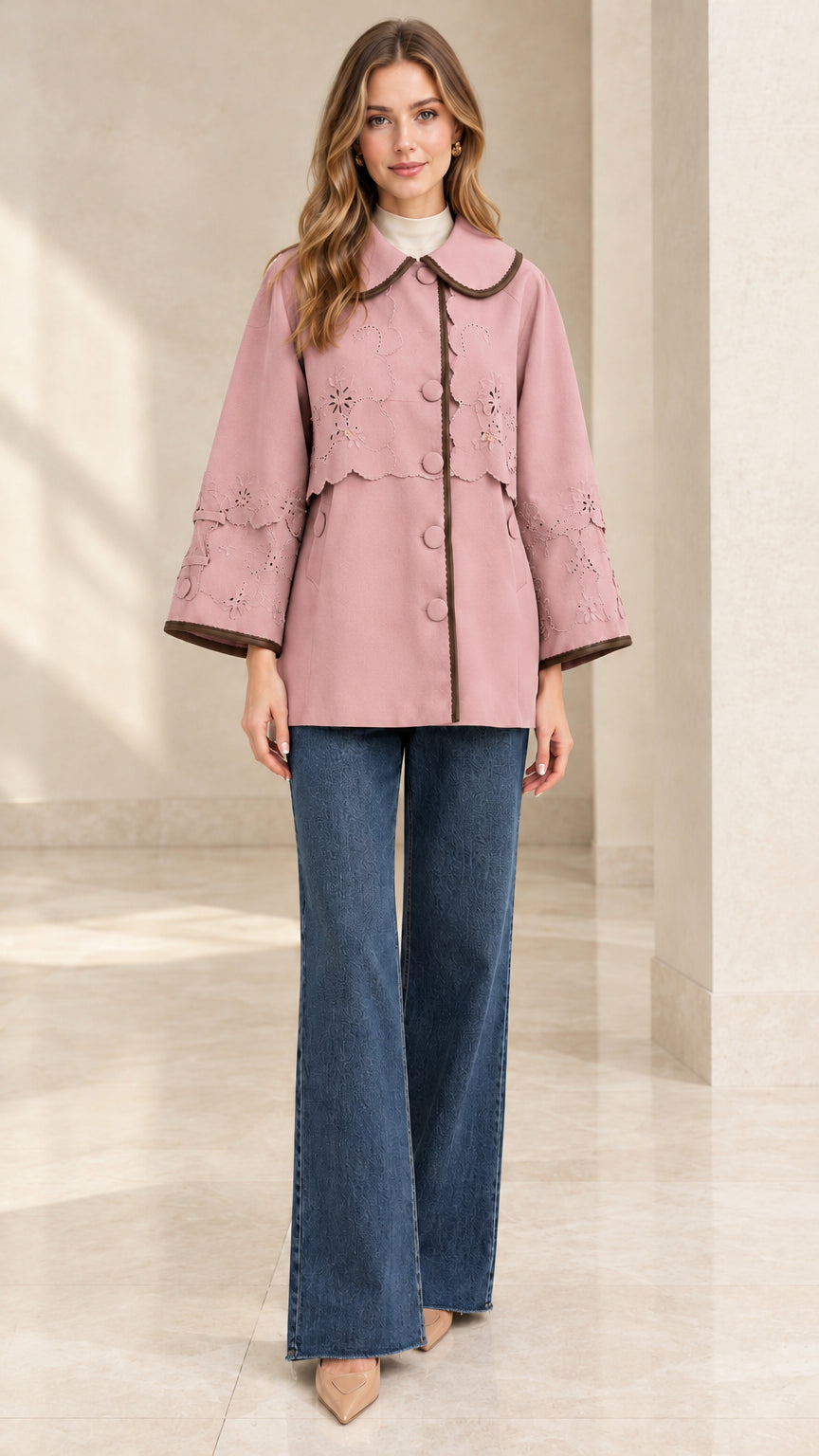 Full-length front view of woman wearing dusty pink embroidered scalloped capelet jacket