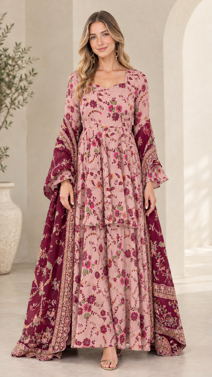 Model wearing dusty pink floral tiered maxi gown with bell sleeves