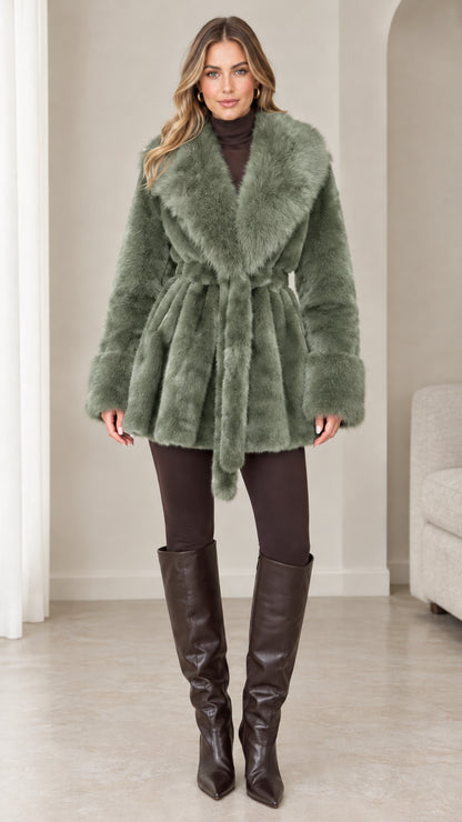 Front view of model wearing sage green plush faux fur belted wrap coat