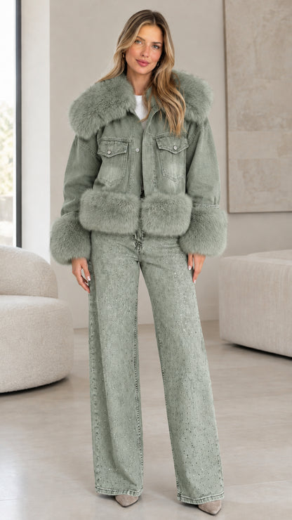 Model wearing sage green washed denim jacket with matching green faux fur trim and wide-leg jeans