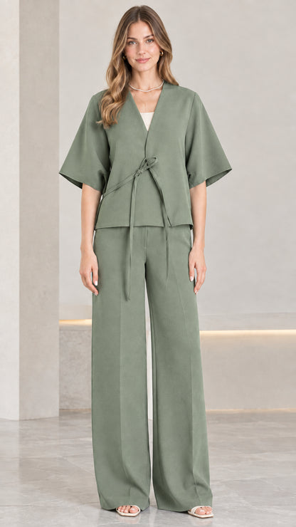 Front view of woman wearing sage green tie-front top and wide-leg pant co-ord set