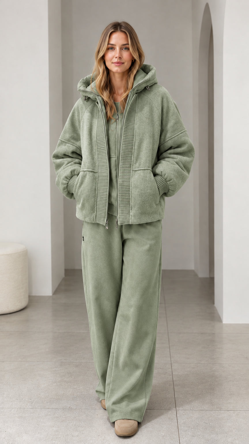 Front view of model wearing sage green textured fleece hooded zip-up jacket