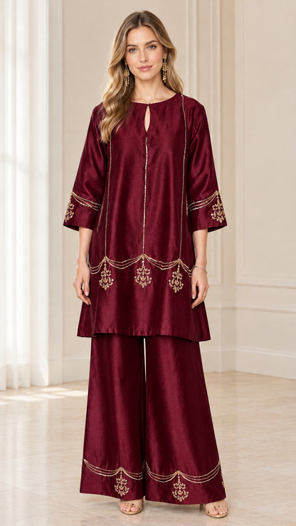 Model wearing burgundy embroidered two-piece tunic top and wide-leg pants set