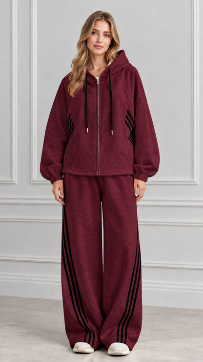 Front view of woman wearing Burgundy zip-up hoodie and wide-leg striped tracksuit set