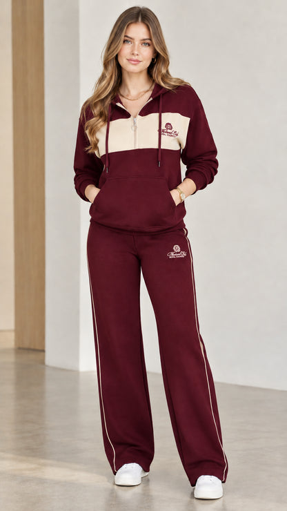 Model wearing burgundy wine colorblock half-zip hoodie and wide-leg sweatpants set