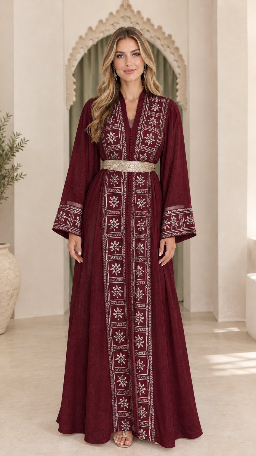Model wearing burgundy red embroidered kaftan maxi dress with gold belt