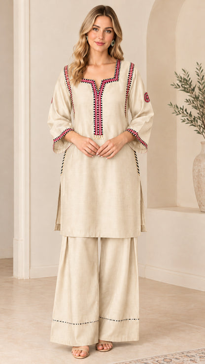 Model wearing Beige embroidered tunic top and matching wide-leg palazzo pants set